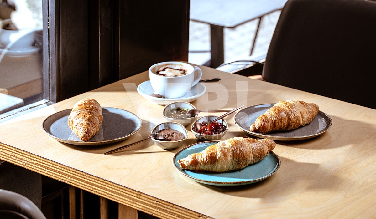 linascafe-linas-yep-yepphotography-gabrielsphotography Breakfast served on a sunny day at a cafe and restaurant. Coffee and croissants.